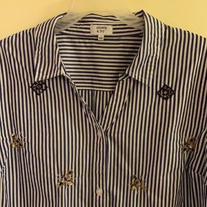 Woman’s size large long sleeve button up shirt.